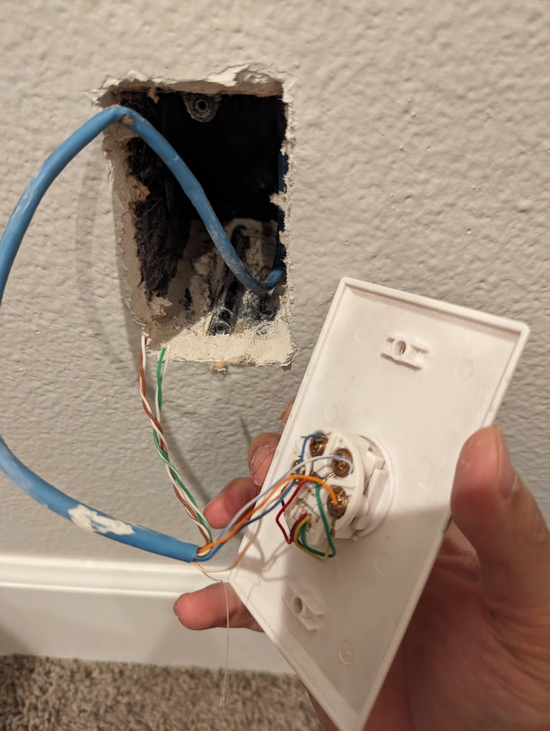 Photo of an opened wall plate that was previously for phone lines